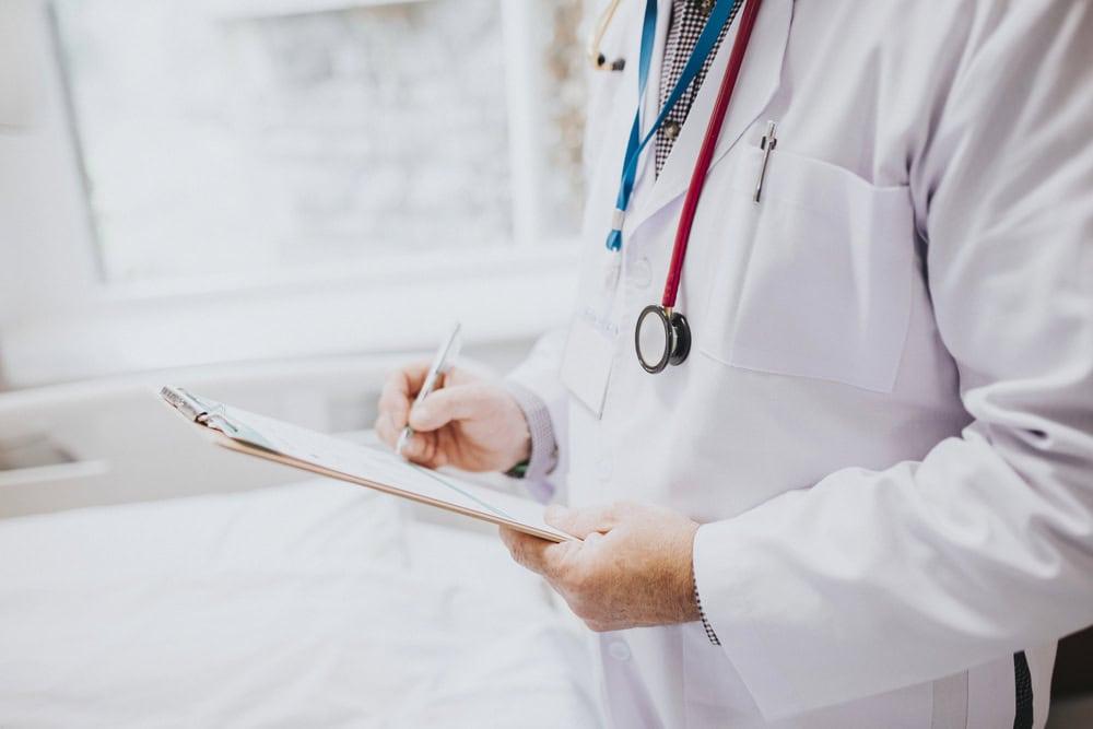 Lawyer reviewing medical records for signs of negligence.