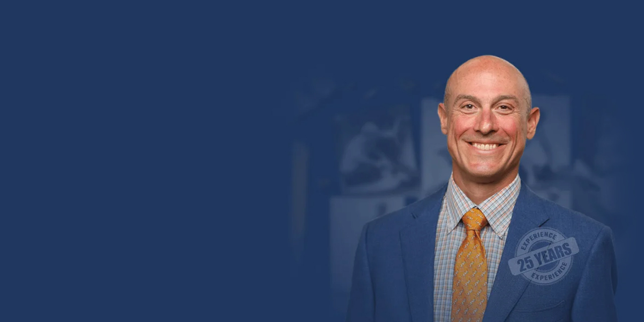 Jonathan Rosenfeld with a dark blue background